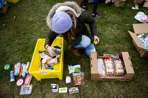 Donating perishable food that is past its prime to food banks allows big supermarket chains to maintain better-looking items on the shelf, resulting in higher prices and larger markups than would otherwise be the case, according to a food waste expert's research. (Pictured) NU Mutual Aid holds a mobile food pantry on the Boston campus. Photo by Ruby Wallau/Northeastern University