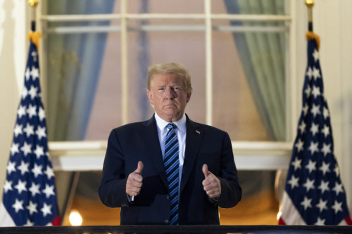 President Donald Trump gives thumbs up on the Blue Room Balcony upon returning to the White House Monday, Oct. 5, 2020, in Washington, after leaving Walter Reed National Military Medical Center, in Bethesda, Md. Trump announced he tested positive for COVID-19 on Oct. 2. AP Photo/Alex Brandon