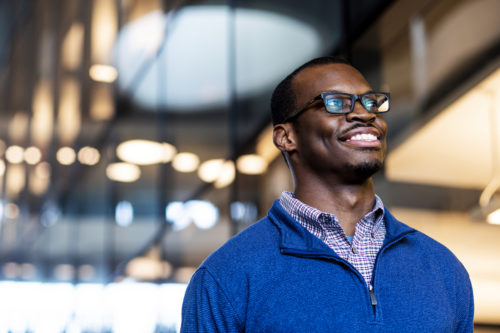 Arlen Agiliga, who will graduate in May and then go on to a university in China for his master's degree through the Schwarzman Scholarship program, poses for a portrait in ISEC. Photo by Alyssa Stone/Northeastern University