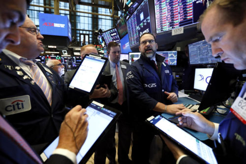 Traders gathered at the post of Specialist Anthony Matesic, background center, on the floor of the New York Stock Exchange, Tuesday, Feb. 18, 2020.  AP Photo/Richard Drew