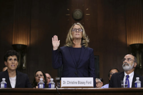 Christine Blasey Ford is sworn in before the Senate Judiciary Committee, Thursday, Sept. 27, 2018 in Washington. Her attorney's Debra Katz and Michael Bromwich watch. (Win McNamee/Pool Image via AP)