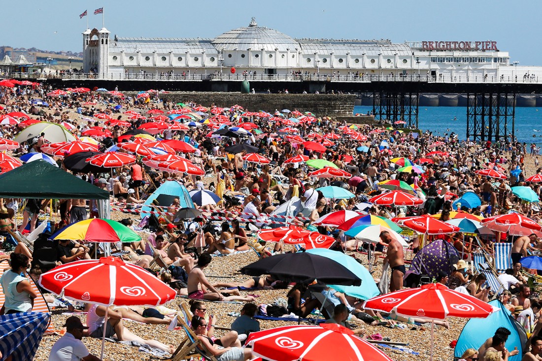 beach crowded with people using beach umbrellas