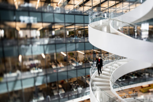 Seen through a tilt-shift lens, a student walks down the spiral stairs in the Interdisciplinary Science & Engineering Complex. Photo by Ruby Wallau/Northeastern University