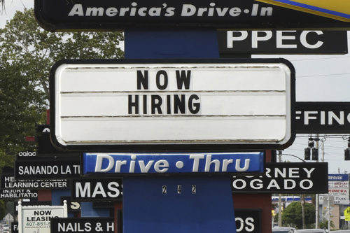 now hiring sign on a Sonic Restaurant sign