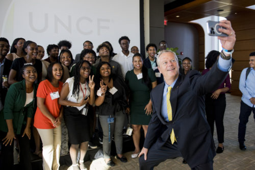 Gov. Charlie Baker poses for a selfie with the inaugural cohort of participants of the UNCF's “Lighted Pathways” and “Ernest E. Just Initiative” programs in Boston at a reception at Northeastern on Thursday, June 9, 2022. Photo by Matthew Modoono/Northeastern University