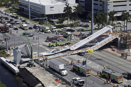 Emergency personnel respond after a brand-new pedestrian bridge collapsed onto a highway at Florida International University in Miami on Thursday. (Pedro Portal/Miami Herald via AP)
