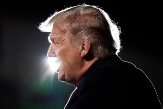 donald trump silhouetted from behind with white light