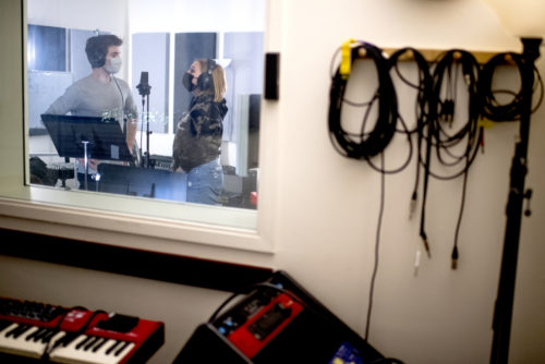 Lily McCollum, who studies theatre and American sign language, and Liam Huff, who studies communication studies with a minor in theatre, work on radio plays at the Shillman Hall recording studio. Photo by Matthew Modoono/Northeastern University
