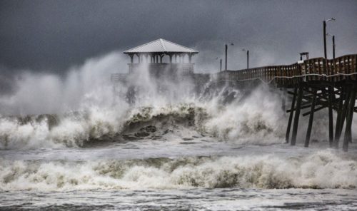 Waves slam the Oceana Pier and Pier House Restaurant in Atlantic Beach, N.C.,  Thursday, Sept. 13, 2018 as Hurricane Florence approaches the area. (Travis Long/The News & Observer via AP)