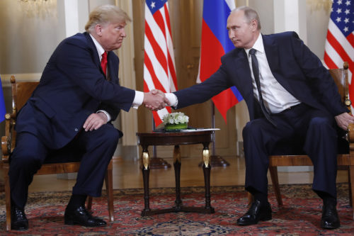 U.S. President Donald Trump, left, and Russian President Vladimir Putin shake hand at the beginning of a meeting at the Presidential Palace in Helsinki, Finland, on Monday, July 16, 2018. (AP Photo/Pablo Martinez Monsivais)