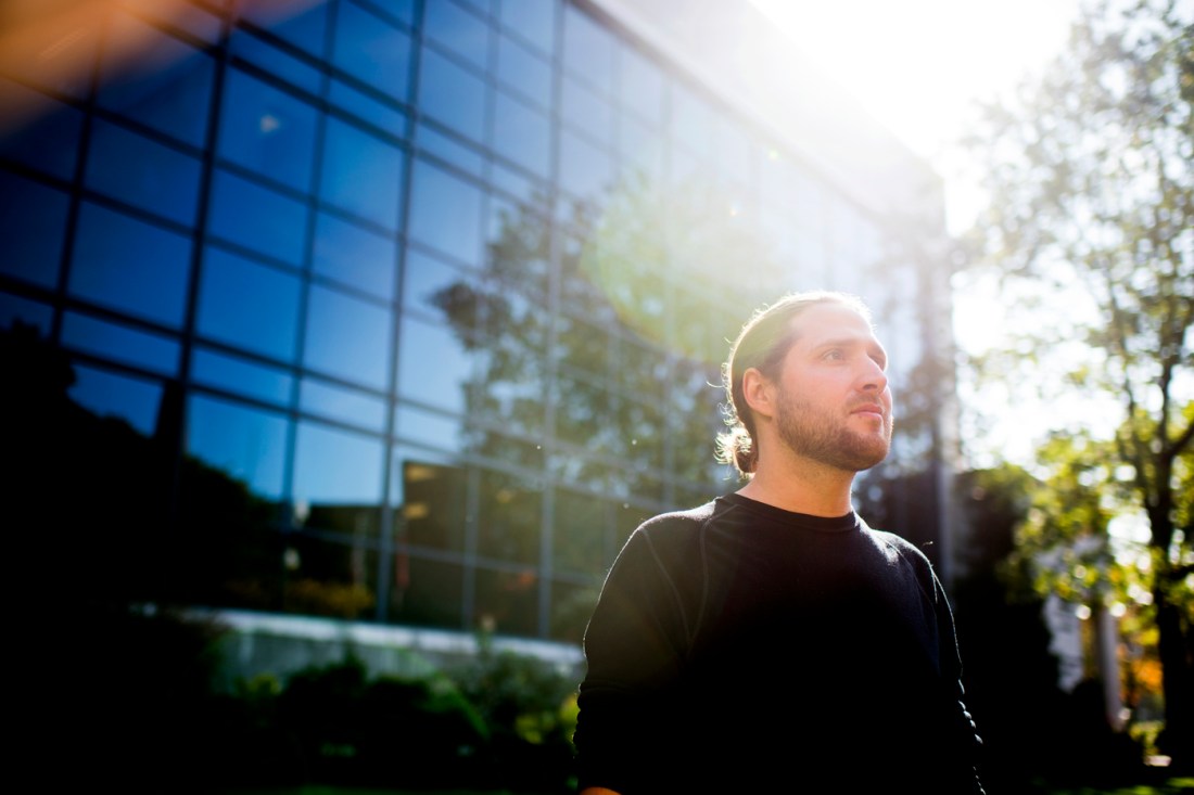 John Basl, an associate professor of philosophy at Northeastern University, stares into the distance on a sunny day.