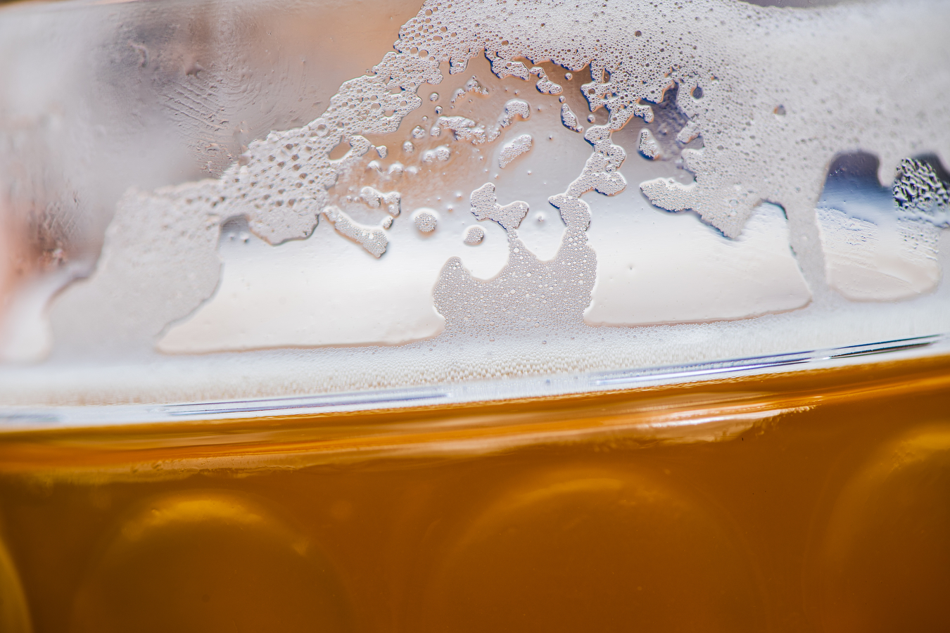 A closeup image of beer in a glass cup. 