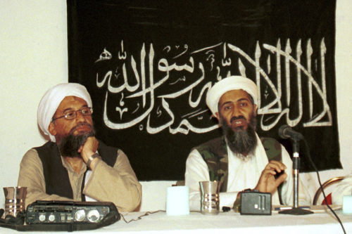 two islamic men sit at a table