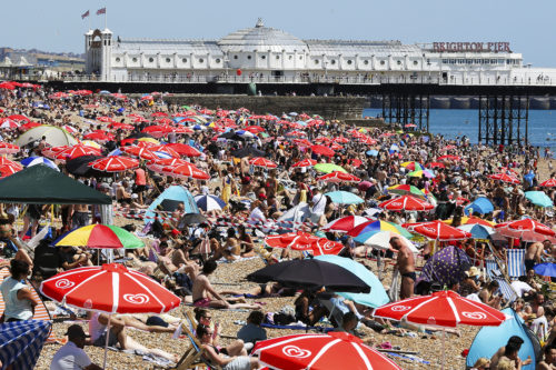 beach crowded with people using beach umbrellas