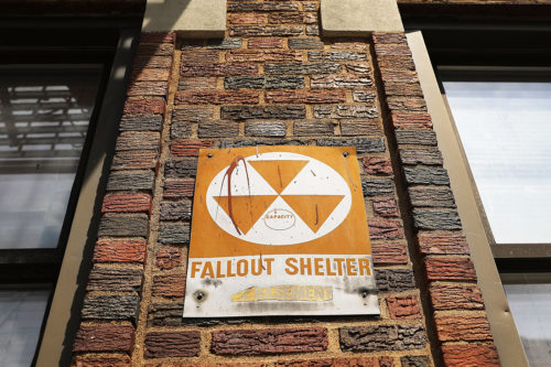 A leftover fallout shelter sign is displayed on a building in New York City. The signs signifying a protective space to sit out a nuclear attack date back to the early 1960s when America was in a Cold War with Russia. Photo by Spencer Platt/Getty Images