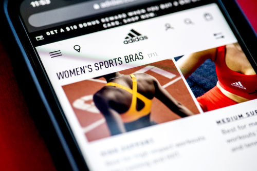 cell phone displaying adidas sports bra web page