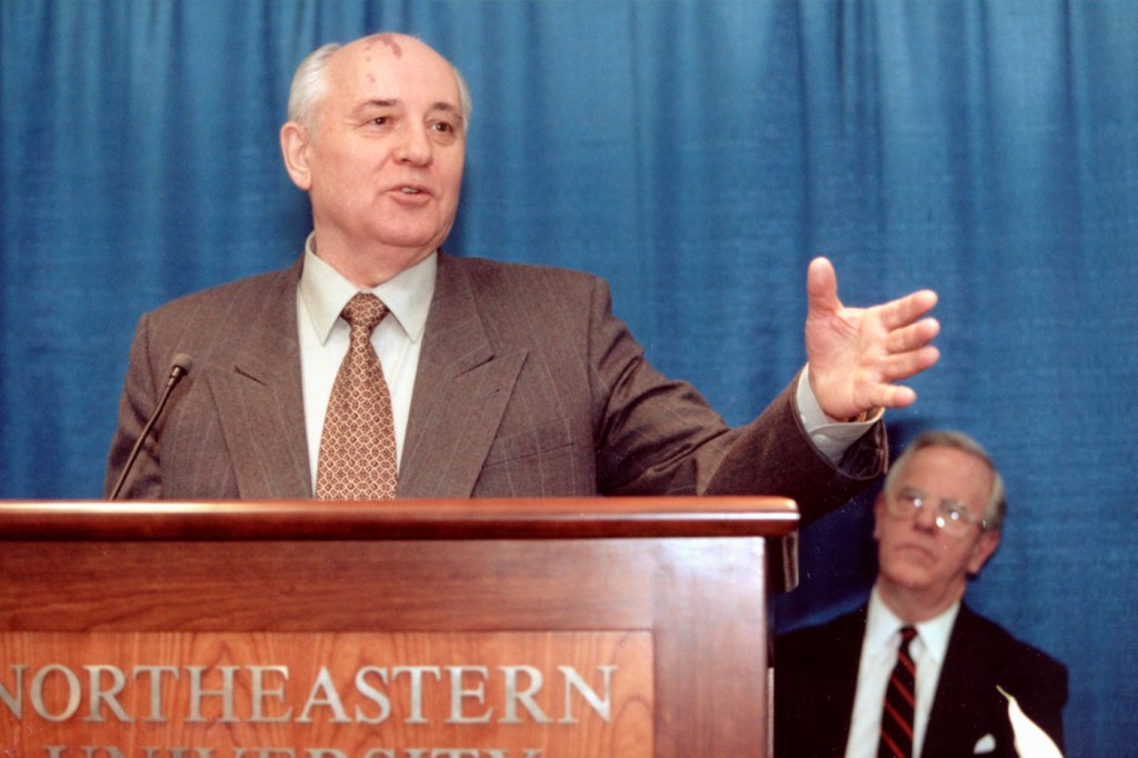 Mikhail Gorbechev stands at a podium with the words 'Northeastern University' on the front