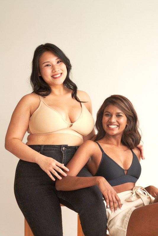two women posing in bras