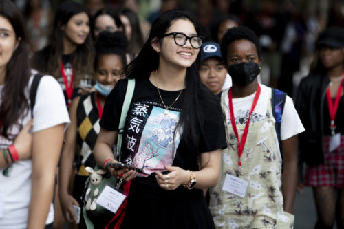 student smiling wearing black t-shirt and glasses