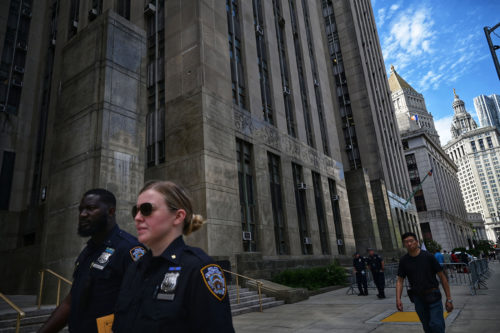People walk past the Criminal Courts building and District Attorneys office  in Manhattan. Photo by ED JONES/AFP via Getty Images