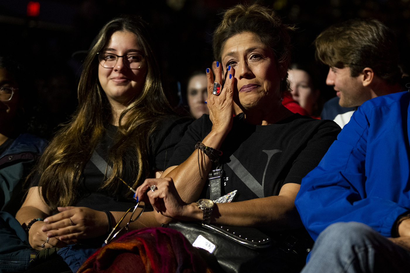 A mother is crying while sitting with her family at Northeastern's Convocation. 