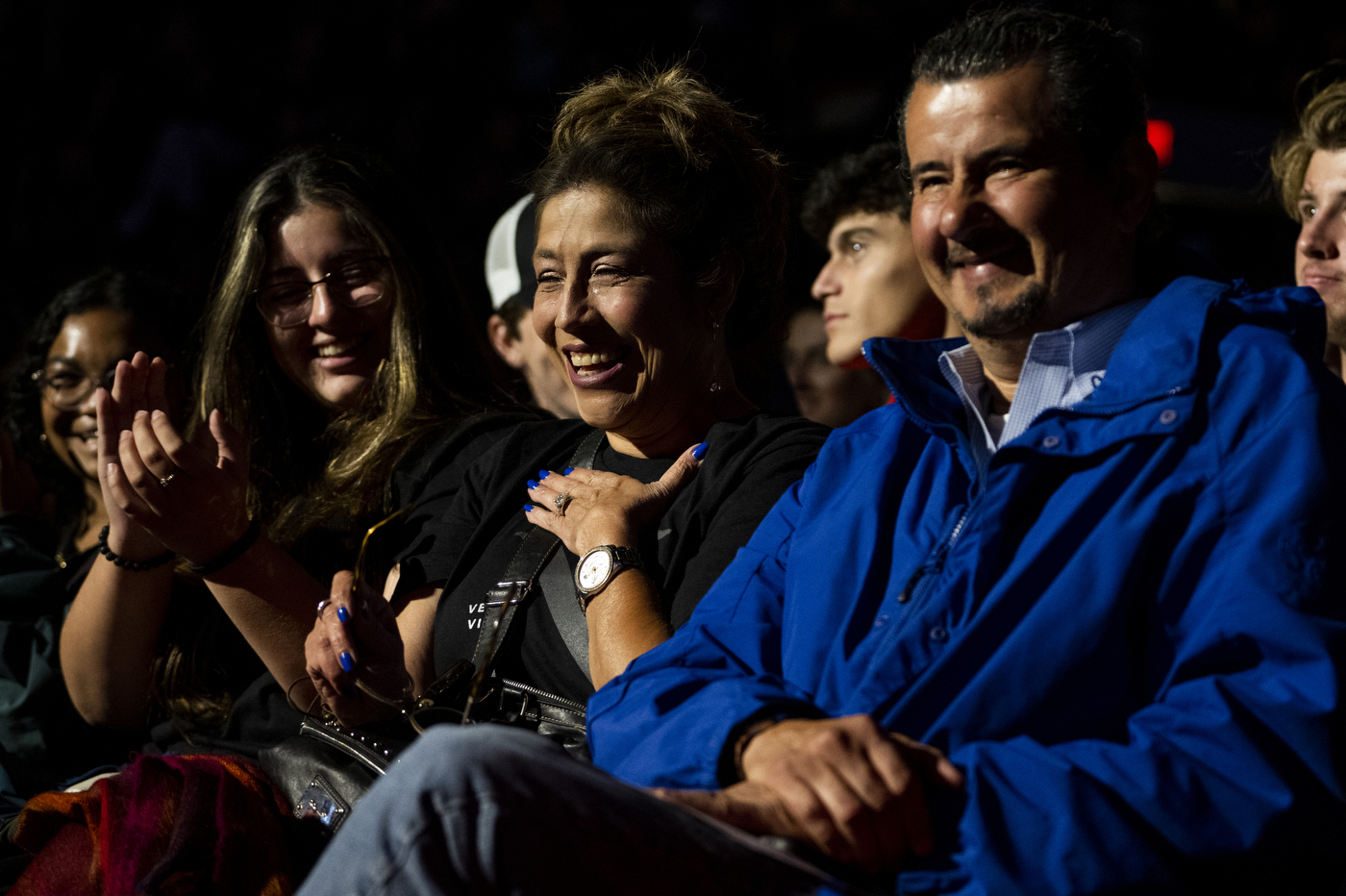 A mother is laughing while sitting with her family at Northeastern's Convocation. 