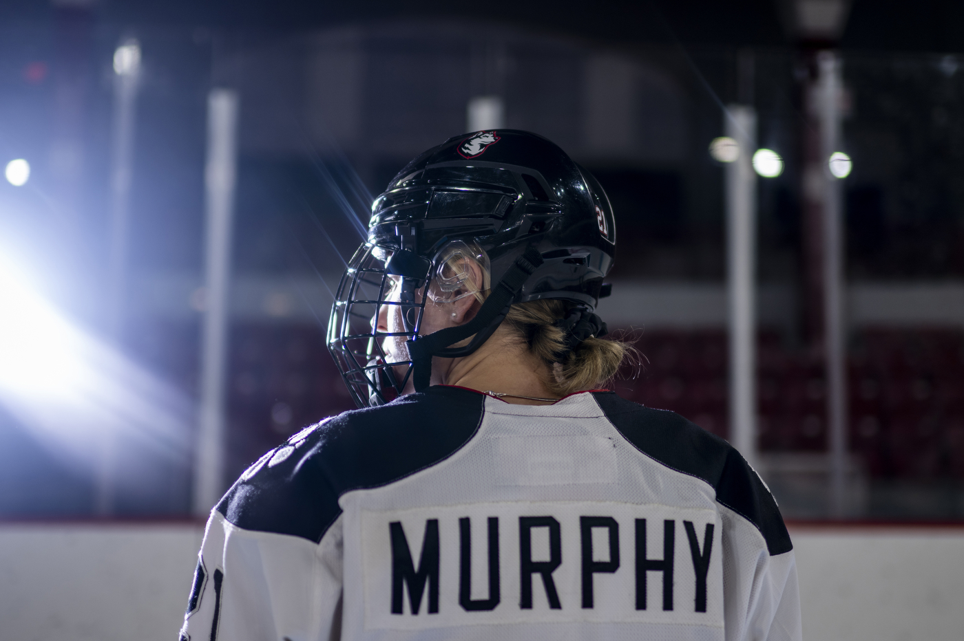 A player on the Northeastern women’s hockey team shows the back of their jersey with black text: 'Murphy.'