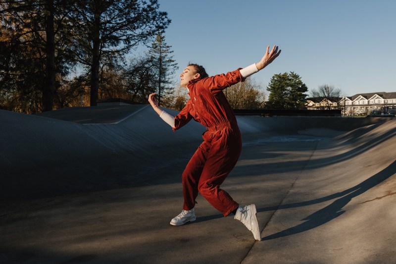 student dancing in red jumpsuit