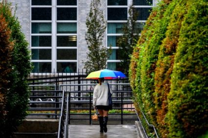 A Northeastern students walks past Curry Student Center during a light rain storm on the Boston campus. Photo by Matthew Modoono/Northeastern University