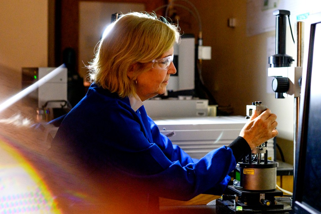 professor laura lewis in lab coat and glasses