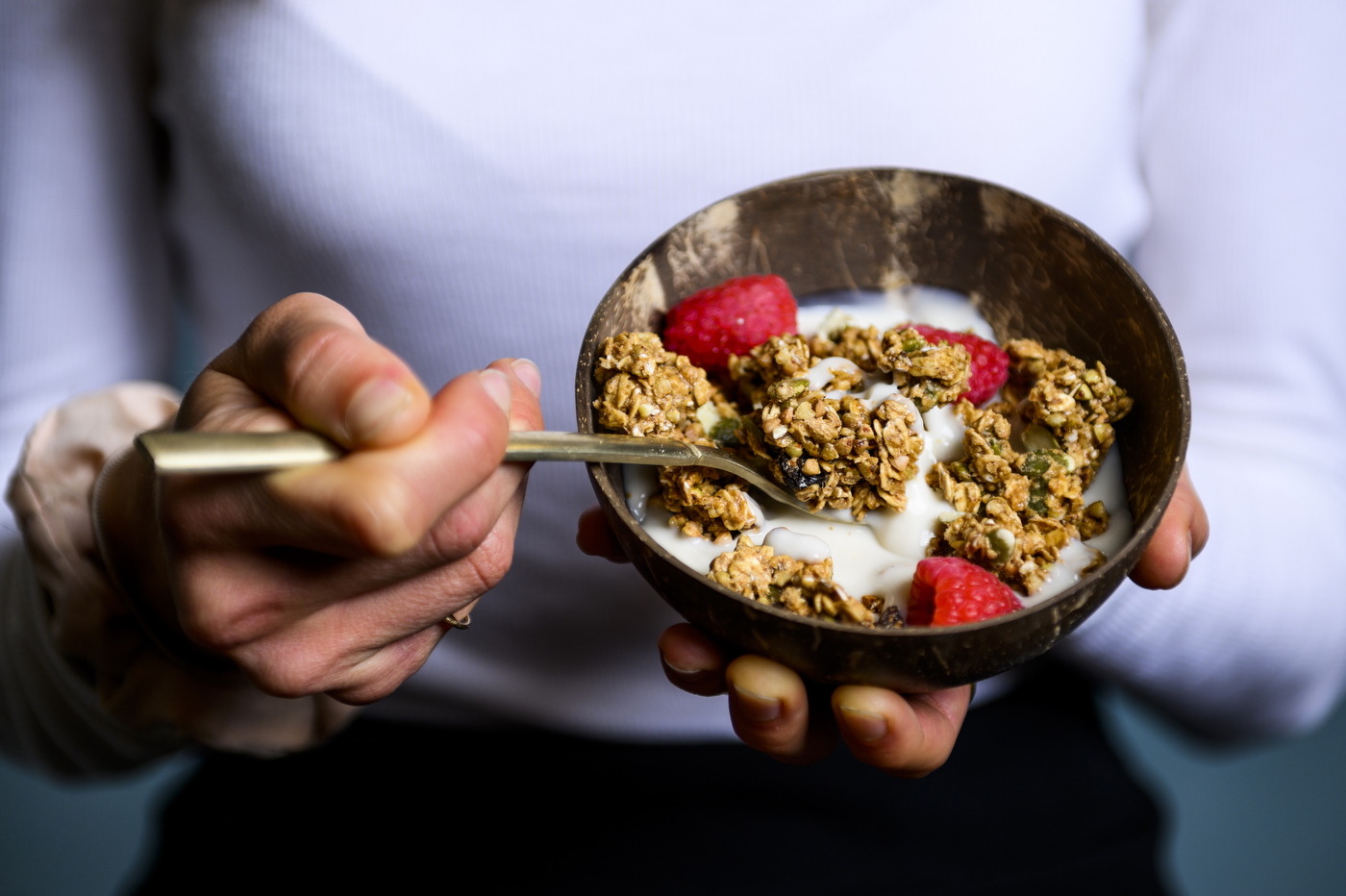 bowl of granola with yogurt and raspberries
