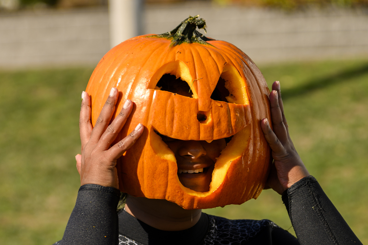person with their head in a jack-o-lantern