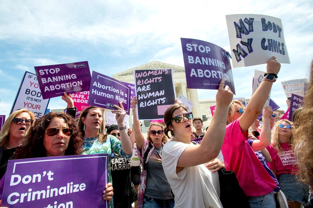 abortion protestors holding signs