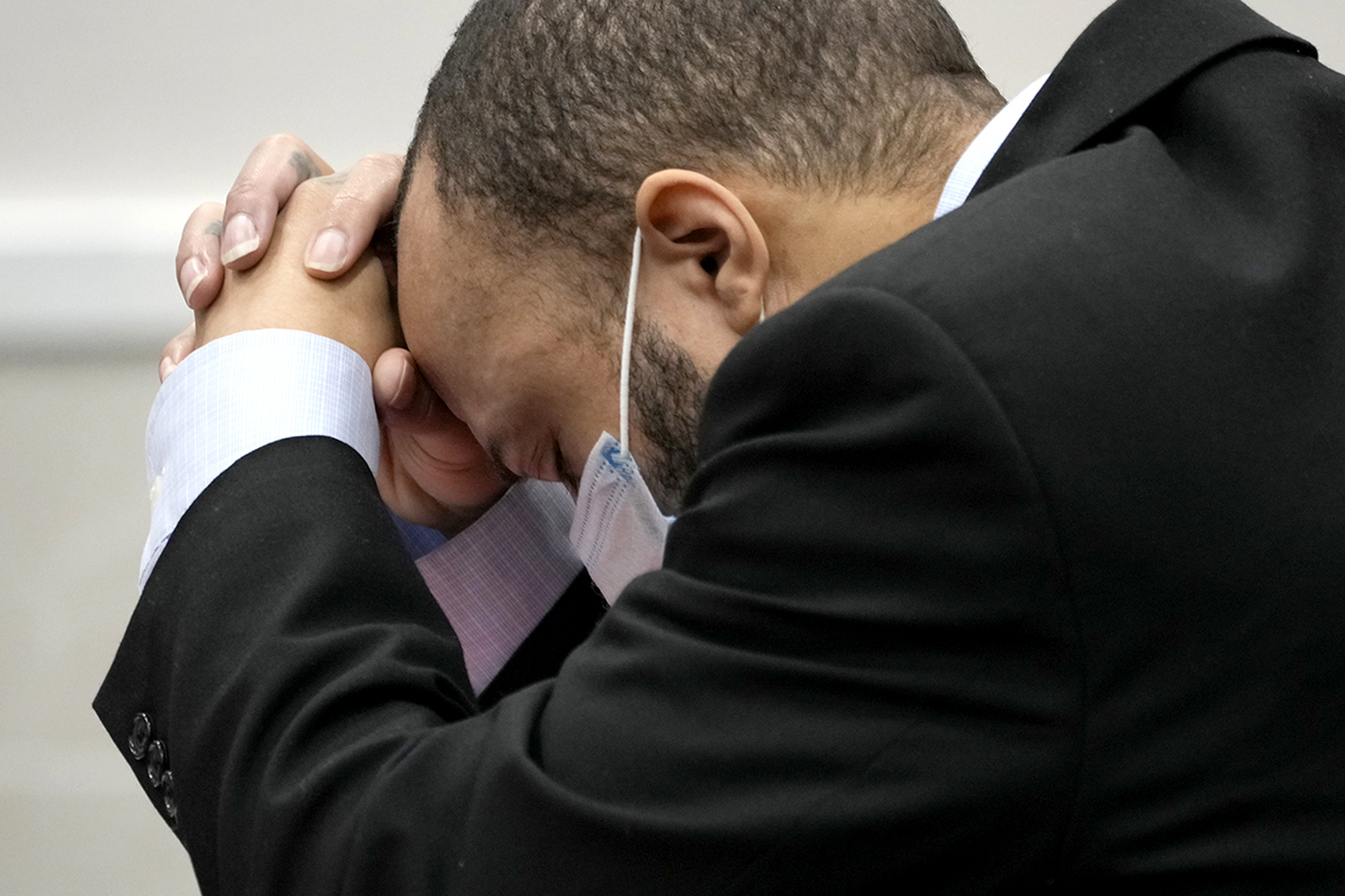 Darrell Brooks leans over, holding his head into his clasped hands