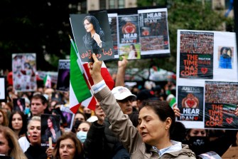 protestors holding flags and pictures