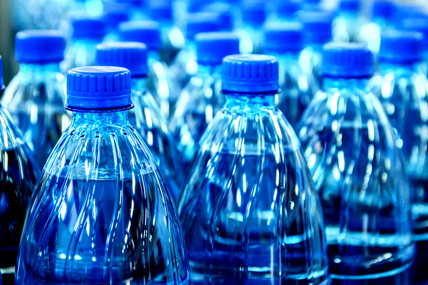 a close up view of the tops of a group of water bottles
