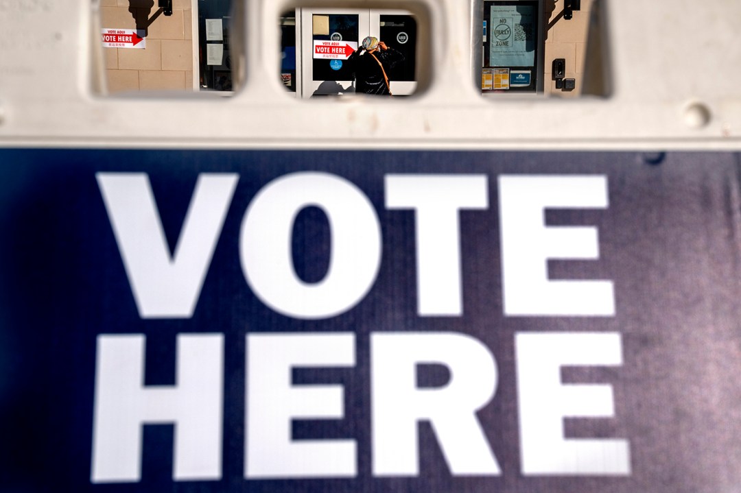 sign with 'VOTE HERE' in all caps