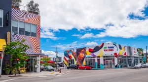Colorful street art and murals cover buildings in Miami’s Wynwood neighborhood, including Art Fusion Galleries on a sunny day.