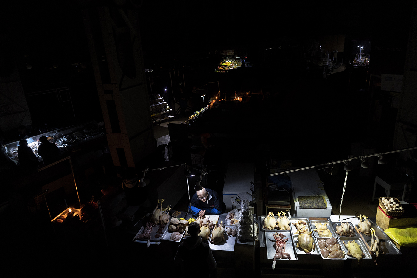 vendors in a market in the dark