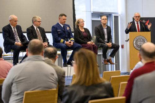 Six people participate in a panel discussion.