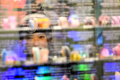 Kayla Wang, who studies computer engineering and computer science, takes a look at the newly installed exhibit titled “At Play” in Gallery 360 in Curry Student Curry Student Center. The exhibit At Play presents work by five female artists navigating and untangling the tensions of play, paying particular attention to the societal expectations and implications placed upon women through these systems. Photo by Matthew Modoono/Northeastern University