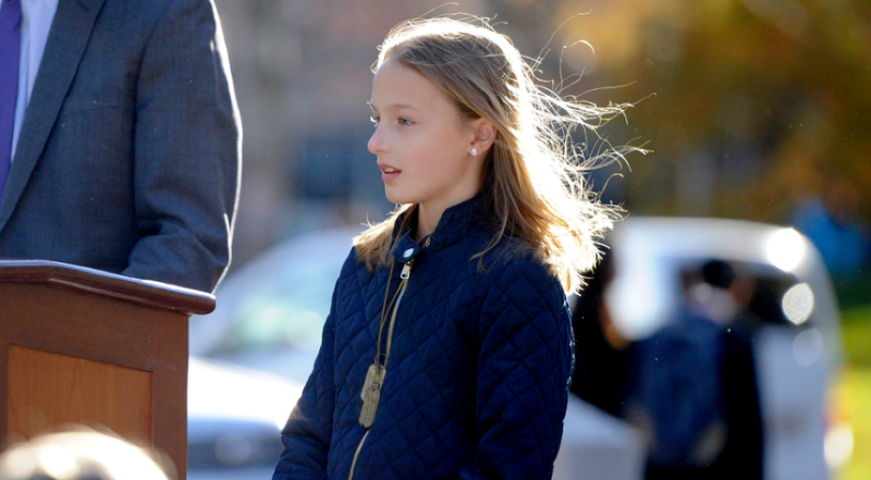 Sydney wearing a blue jacket and dog tags.