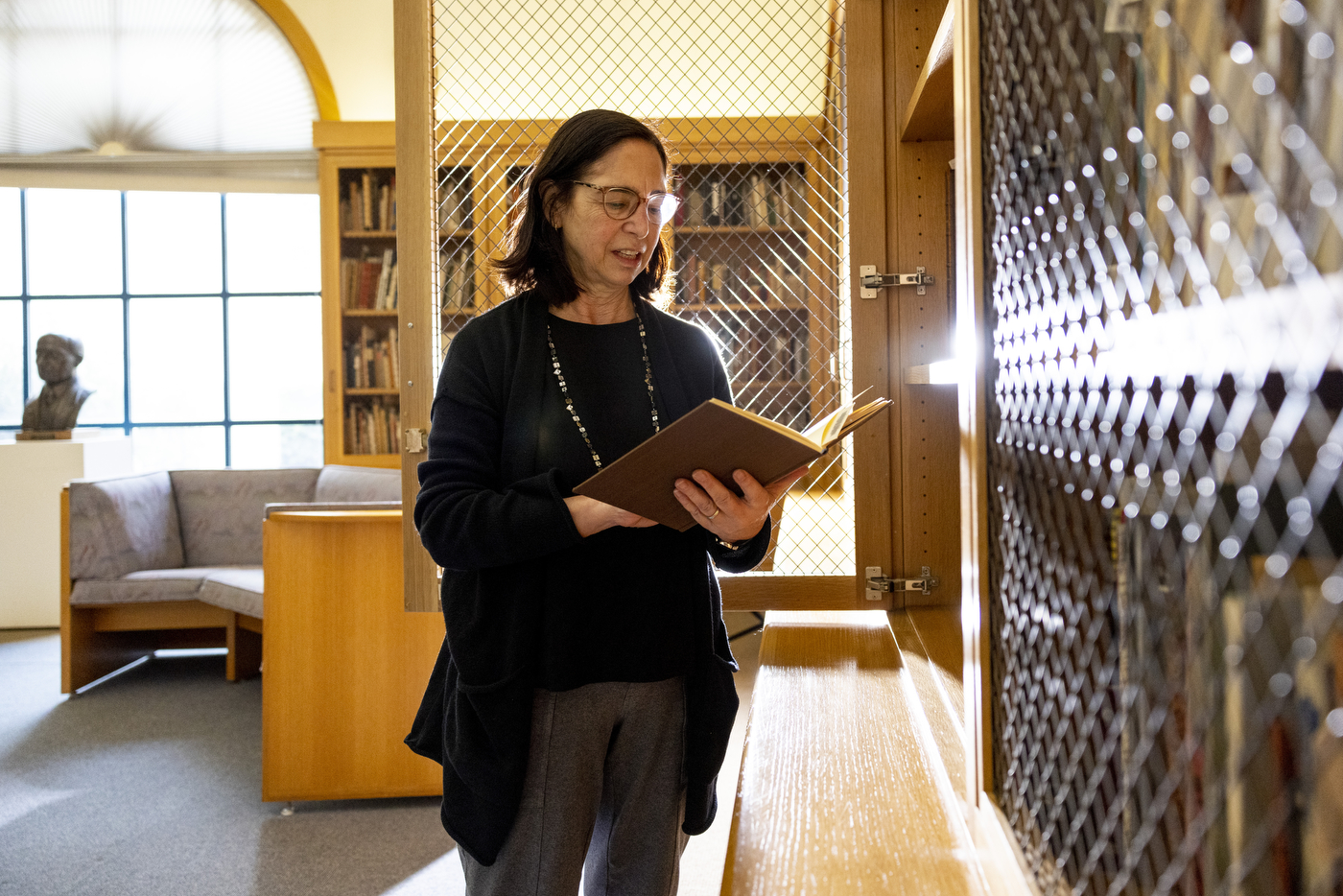 Librarian Janice Braun looks through the Special Collections within the Heller Rare Book Room at the Mills College Library.