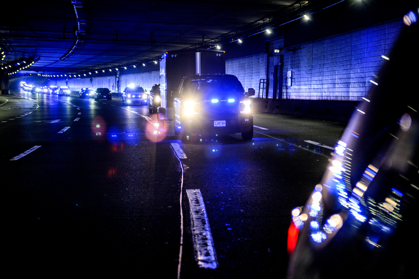 police convoy driving through a tunnel
