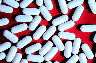 white pills on red background