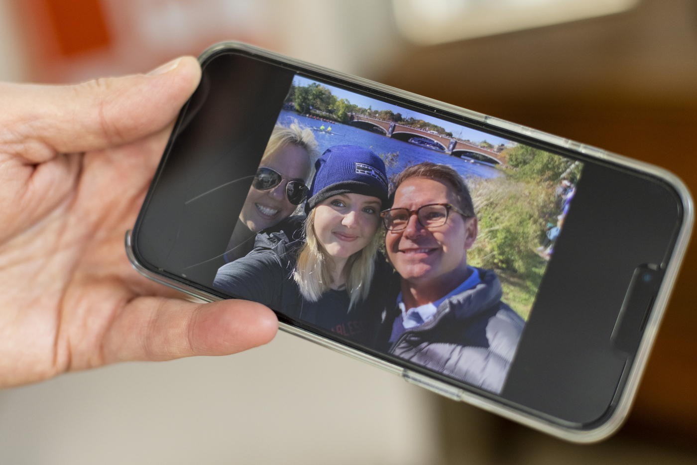 phone showing selfie of northeastern student with parents
