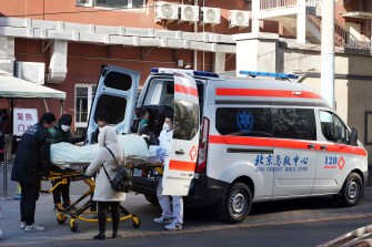 A patient is carried to a fever clinic by an ambulance in Beijing, China.