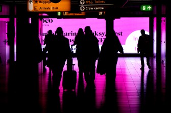 silhouette of people walking through an airport