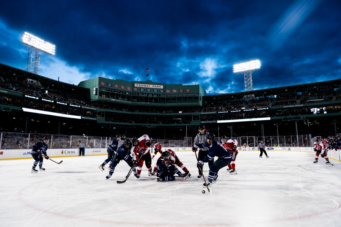 Northeastern hockey players playing on the rink in Fenway Park for Frozen Fenway. 