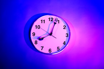 white clock on a blue and purple gradient background